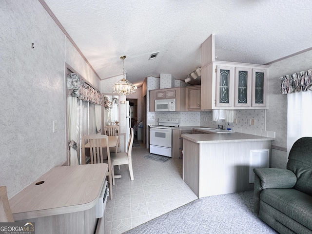 kitchen with crown molding, lofted ceiling, white appliances, and kitchen peninsula