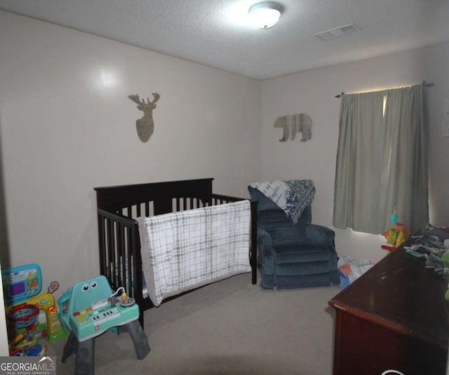 bedroom with carpet flooring and a textured ceiling