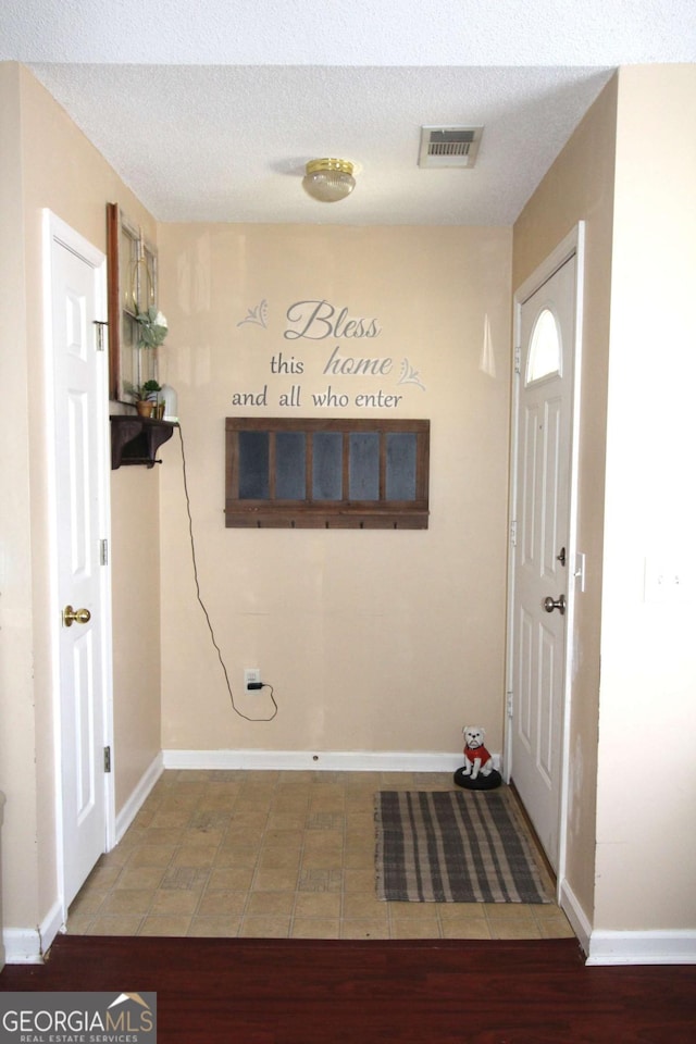 entrance foyer featuring hardwood / wood-style floors and a textured ceiling