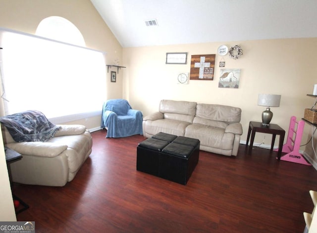 living room featuring vaulted ceiling and dark hardwood / wood-style floors