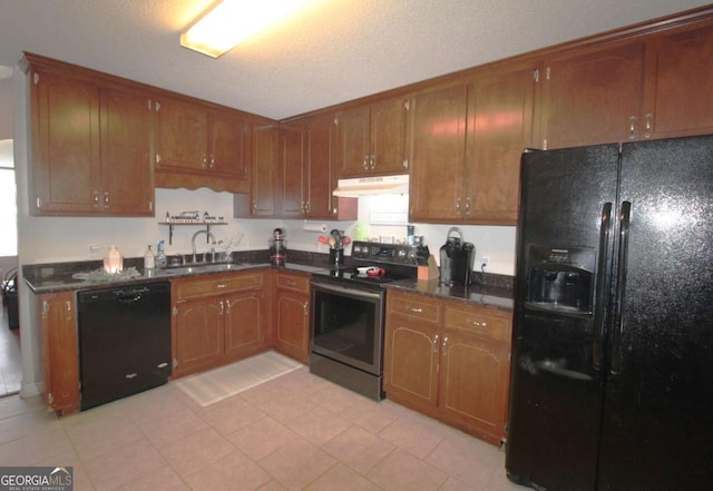 kitchen with sink, light tile patterned floors, a textured ceiling, and black appliances