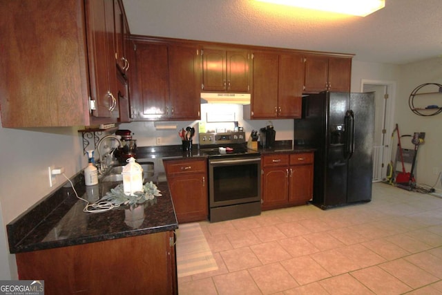 kitchen with sink, stainless steel electric range, dark stone counters, and black fridge