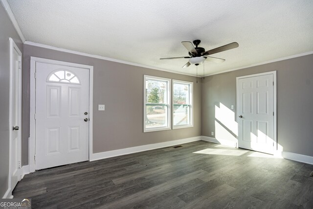 entrance foyer with ornamental molding, dark hardwood / wood-style floors, ceiling fan, and a textured ceiling