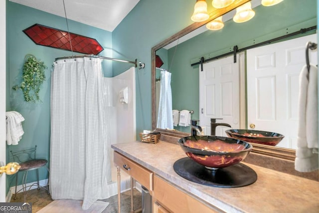 bathroom featuring vanity and a shower with shower curtain