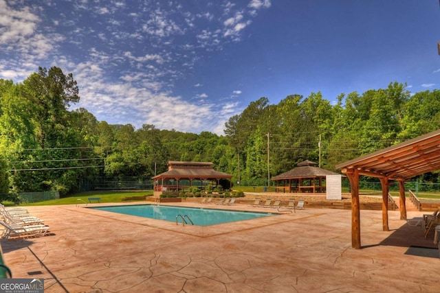 view of swimming pool with a gazebo, a patio area, and a lawn