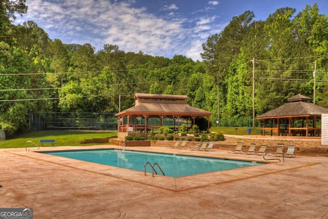 view of pool featuring a gazebo, a yard, and a patio area