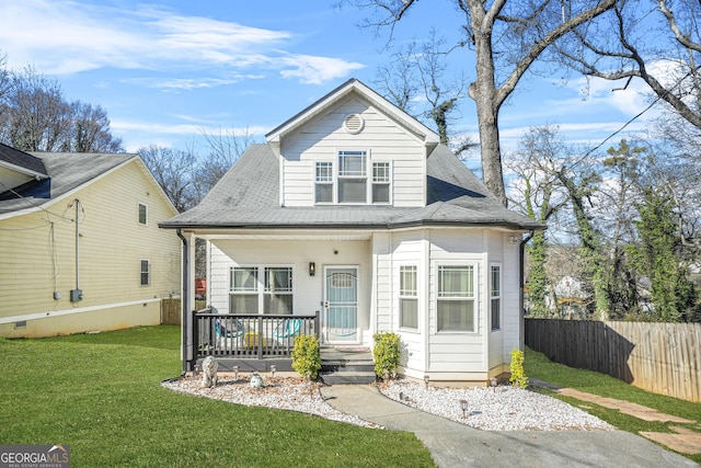 bungalow-style house featuring covered porch and a front yard