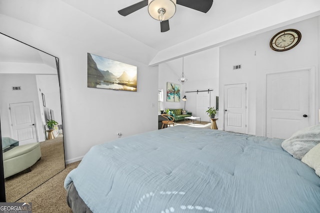 bedroom featuring a barn door, carpet floors, lofted ceiling, and ceiling fan