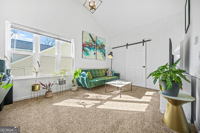 interior space with high vaulted ceiling, a barn door, and carpet floors