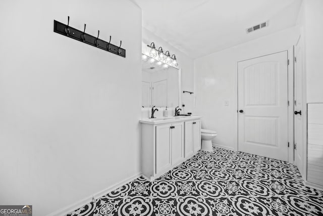 bathroom with vanity, toilet, and tile patterned flooring