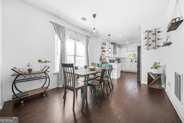 dining room with dark wood-type flooring and sink