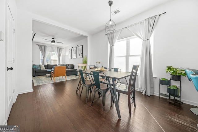 dining space with dark wood-type flooring and ceiling fan