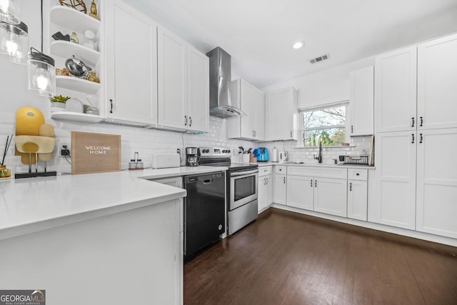 kitchen with stainless steel electric stove, white cabinetry, black dishwasher, hanging light fixtures, and wall chimney range hood