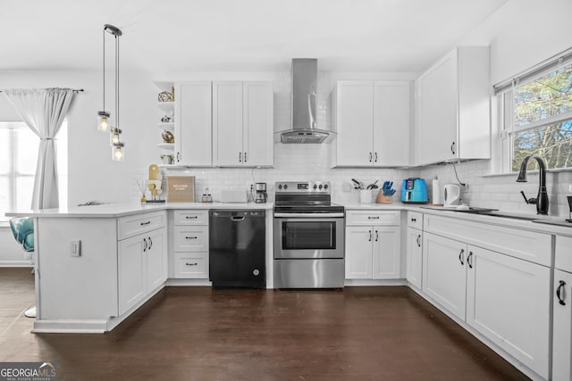 kitchen featuring stainless steel electric range oven, white cabinetry, black dishwasher, kitchen peninsula, and wall chimney range hood