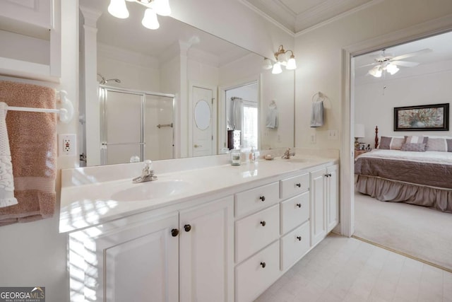 bathroom featuring vanity, a shower with shower door, ornamental molding, and ceiling fan