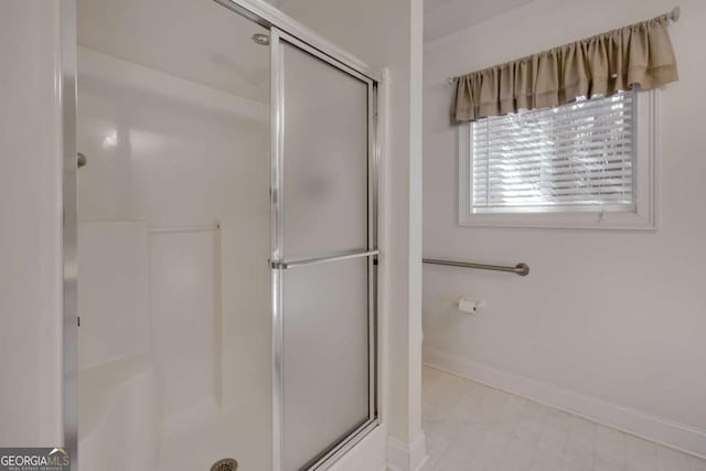 bathroom featuring a shower with door