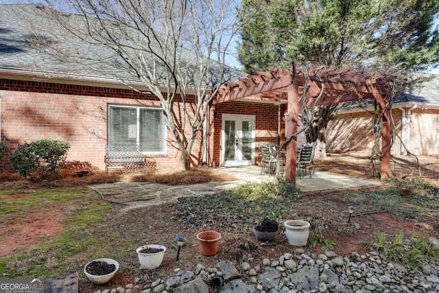 view of front of home with french doors, a patio area, and a pergola