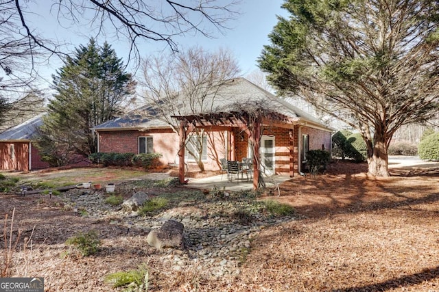 rear view of house with a patio and a pergola