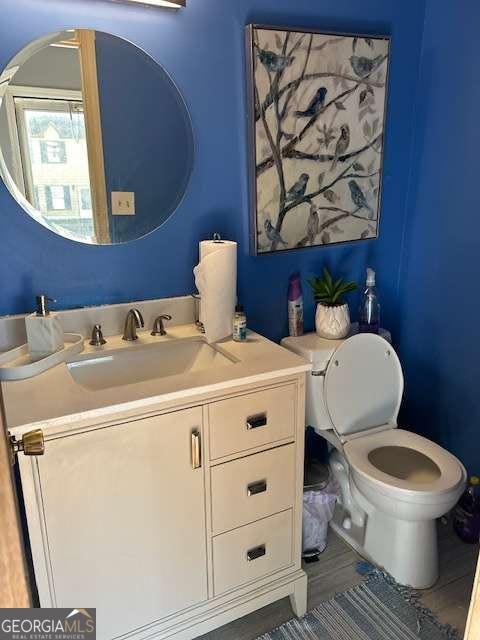 bathroom featuring vanity and toilet