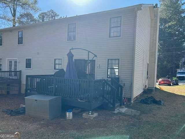 back of house with a deck