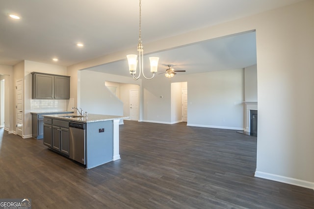 kitchen featuring sink, decorative backsplash, a center island with sink, decorative light fixtures, and stainless steel dishwasher