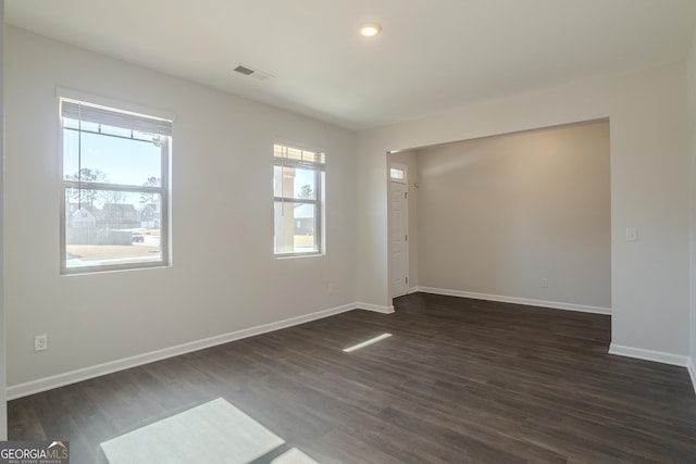 empty room featuring dark hardwood / wood-style floors and a wealth of natural light