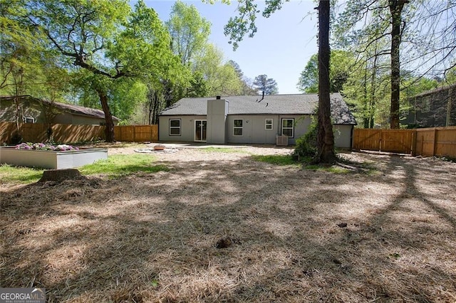 rear view of property with central AC