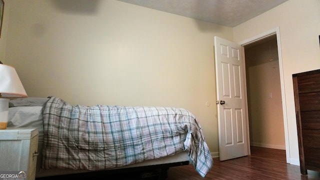 bedroom featuring dark hardwood / wood-style flooring