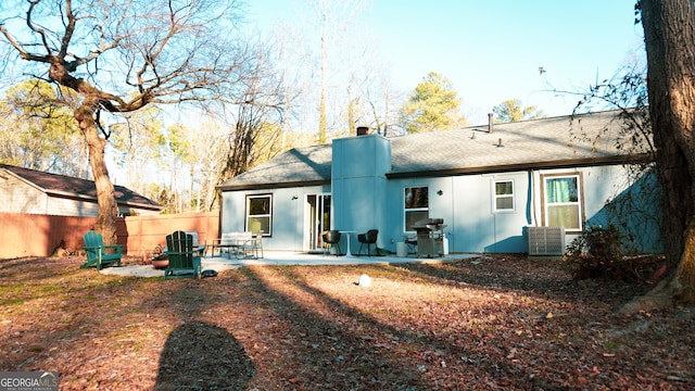 back of property with a patio and central air condition unit