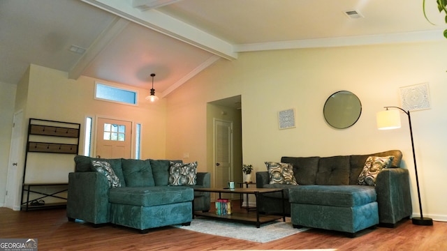 living room with hardwood / wood-style flooring and vaulted ceiling with beams