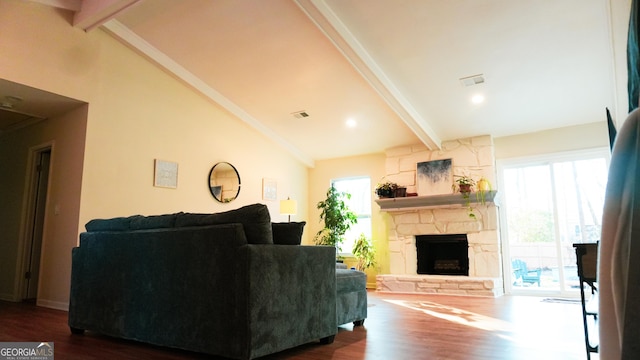 living room with plenty of natural light, dark hardwood / wood-style floors, and beam ceiling