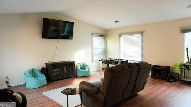 living room with wood-type flooring and vaulted ceiling