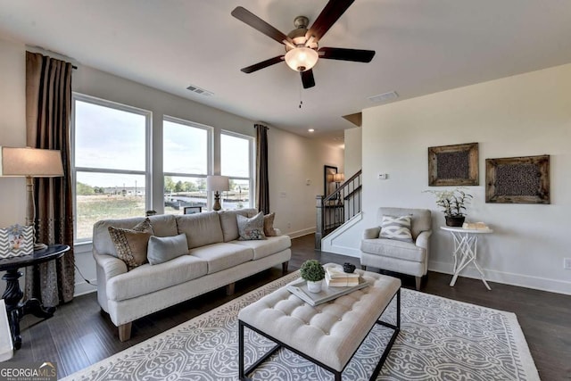 living room with dark hardwood / wood-style flooring and ceiling fan