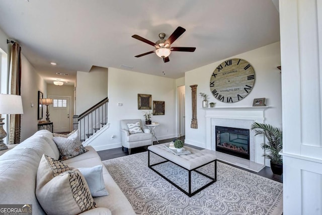 living room featuring wood-type flooring and ceiling fan