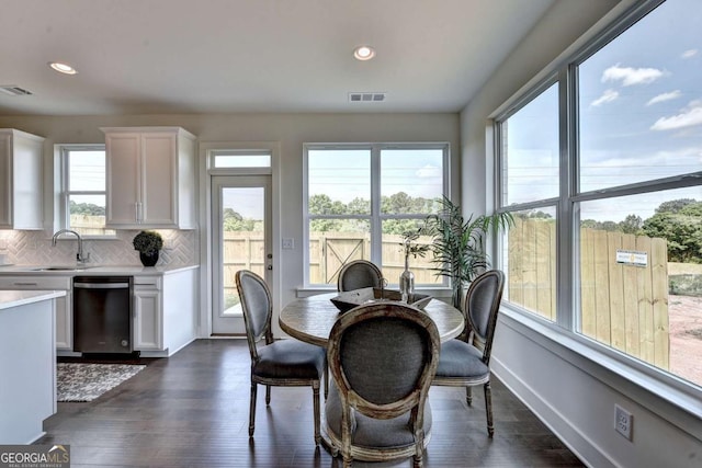 dining room with dark hardwood / wood-style flooring and sink