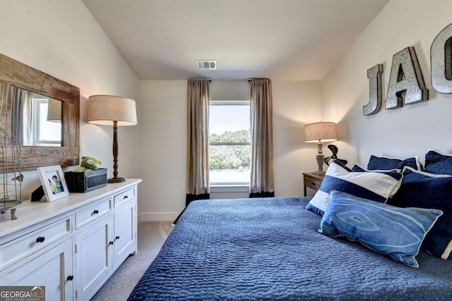 carpeted bedroom with lofted ceiling