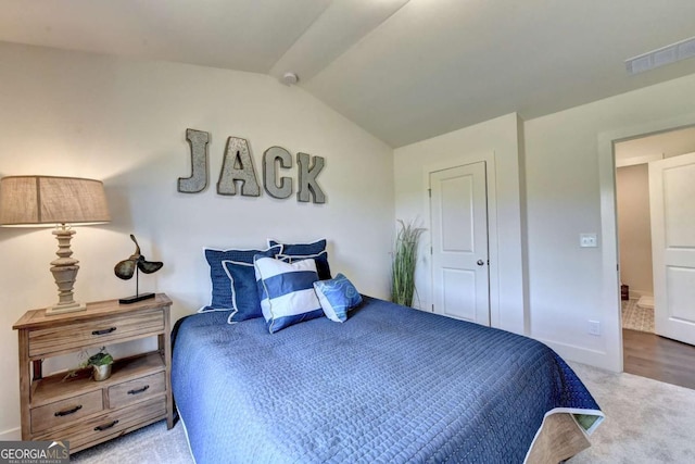 bedroom featuring light carpet and vaulted ceiling with beams