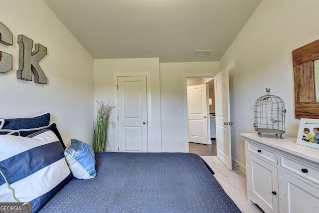 bedroom with light colored carpet