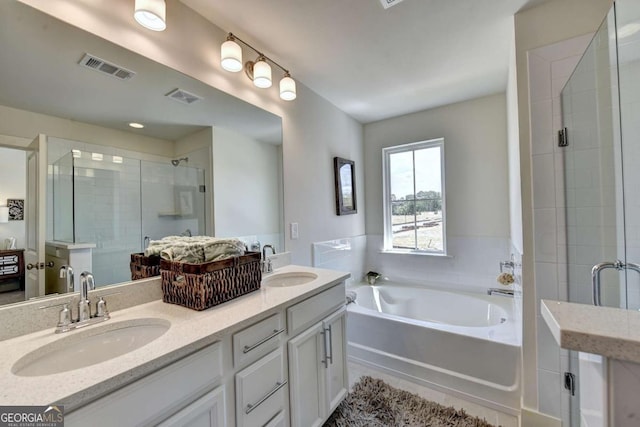 bathroom featuring vanity and shower with separate bathtub