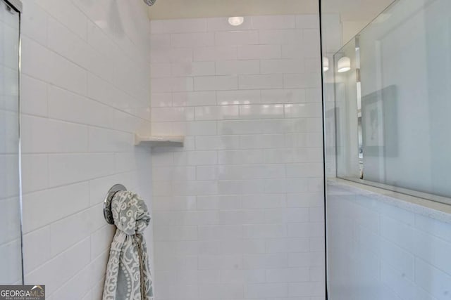 interior details featuring tiled shower