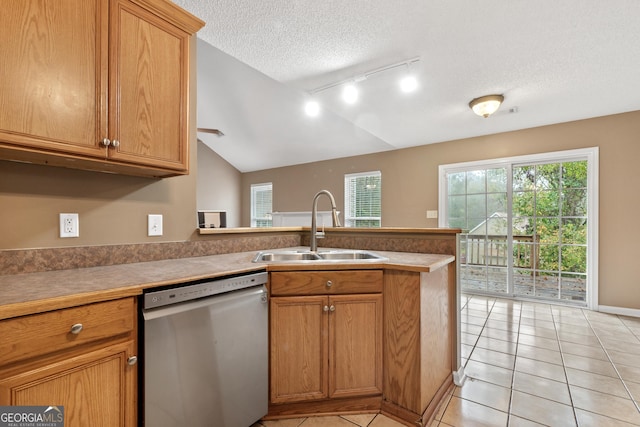 kitchen featuring sink, a textured ceiling, light tile patterned floors, and dishwasher