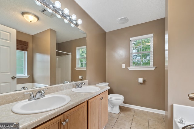 full bathroom with tile patterned flooring, vanity, a textured ceiling, shower with separate bathtub, and toilet