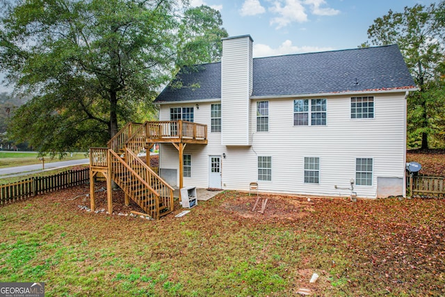 back of house with a wooden deck