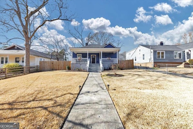 bungalow-style house featuring a front lawn and covered porch