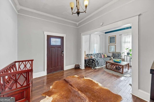 entryway featuring ornamental molding, dark wood-type flooring, and a notable chandelier