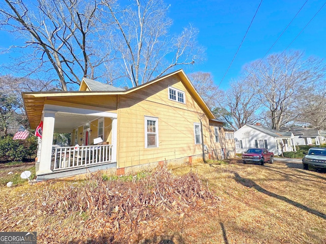 view of side of property with a porch