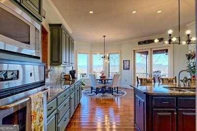 kitchen with sink, hanging light fixtures, a notable chandelier, stainless steel appliances, and plenty of natural light