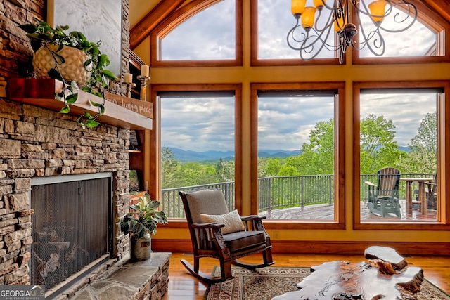 4431 Furman Gribble Rd, Young Harris, GA 30582 - sunroom featuring wood finished floors, a chandelier, a mountain view, and a towering ceiling