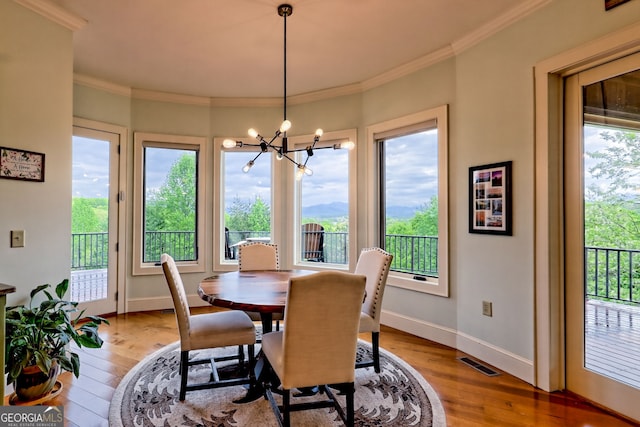 4431 Furman Gribble Rd, Young Harris, GA 30582 - dining room featuring light wood-type flooring, a chandelier, healthy amount of natural light, and ornamental molding