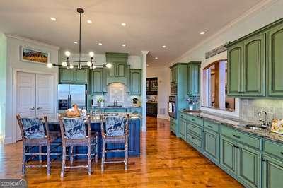 kitchen with wall oven, sink, built in fridge, and a breakfast bar area